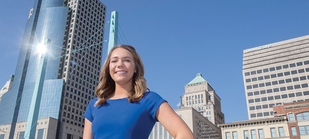 Portfolio 2018, Emily Bleuher Emily Bleuher standing in downtown Cincinnati with office buildings visible in the background