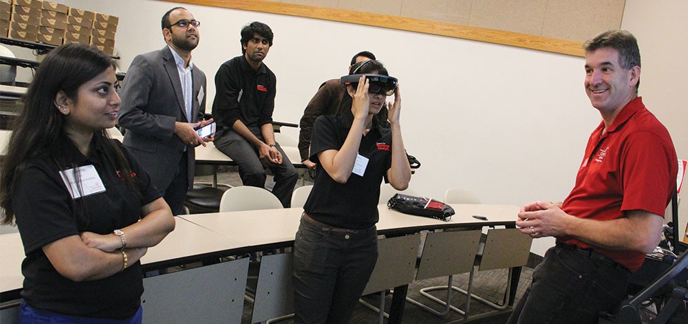Portfolio 2018, Boyd Award: Dave Rapien Professor Dave Rapien demonstrates the Microsoft HoloLens to a group of Lindner graduate students.